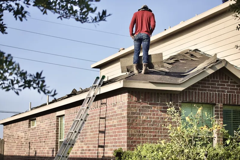 Professional roofer working on a residential roof in Cortlandt Manor
